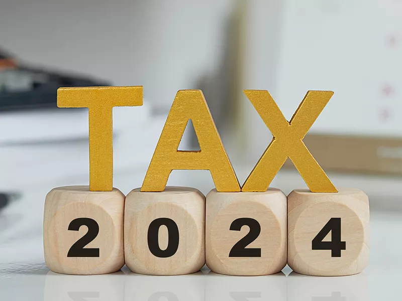 The word tax above wooden blocks reading 2024